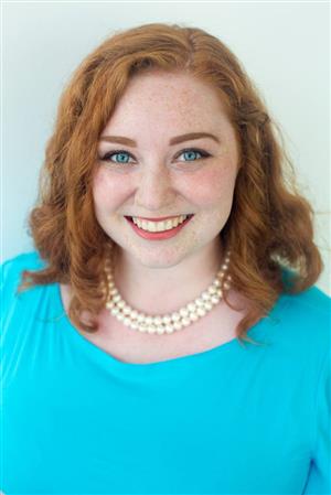 Ms. Reinikka photo, wearing blue dress and pearls