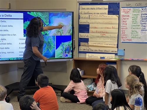 teacherand students with flat panels in classroom