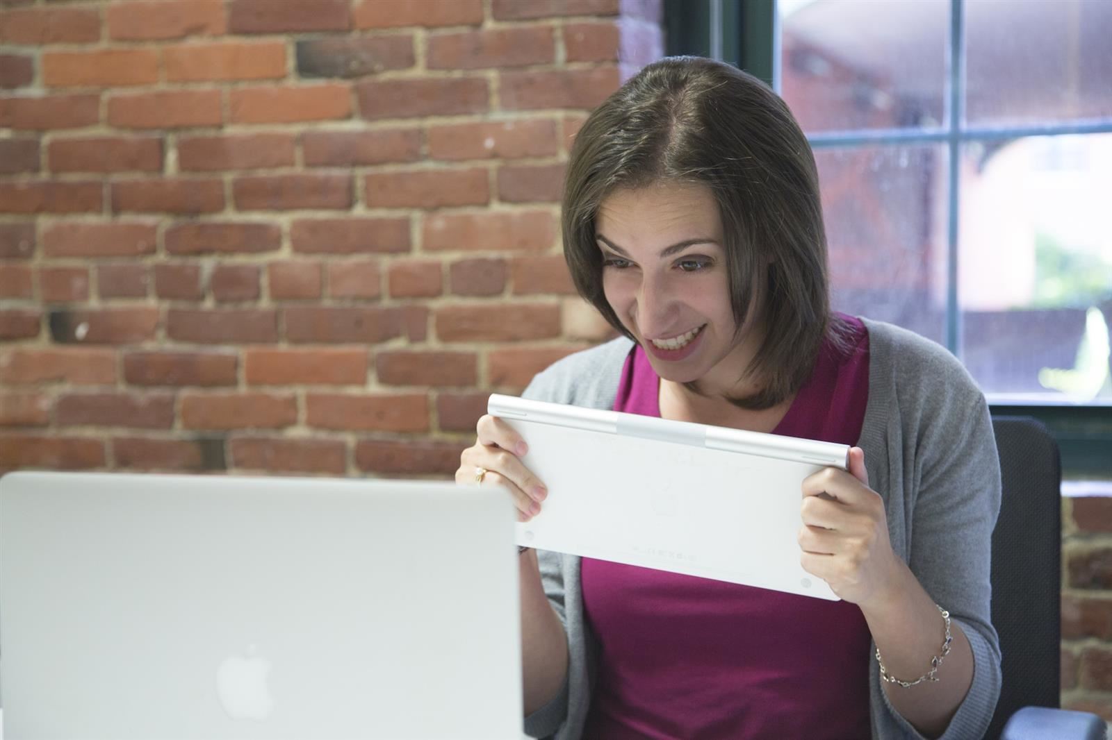  student showing a piece of paper one zoom