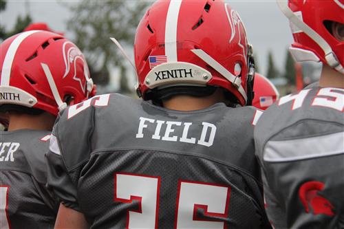 Youth Football Players Standing Next to the Field 