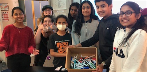 Students pick up recycled pens, markers, and glue sticks.  One week and half a box is full, keep recycling! 